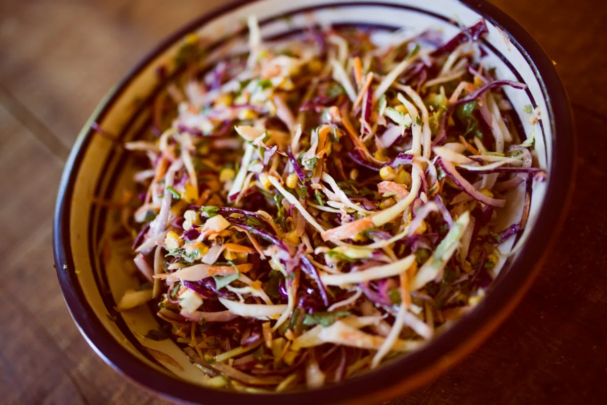 A bowl of coleslaw with red and white cabbage