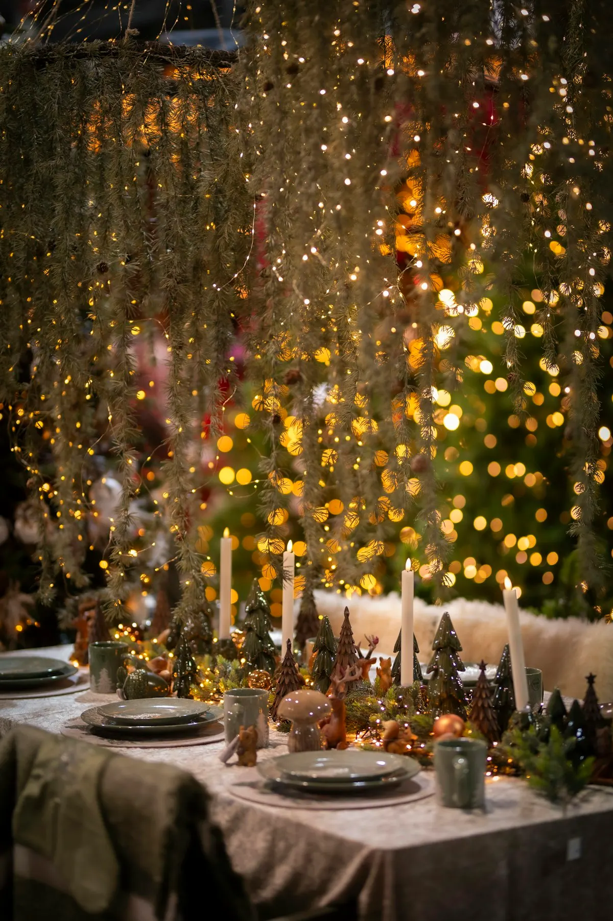 A table laid for a winter celebration with warm lights above